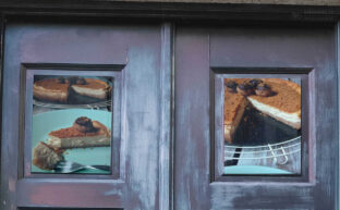 marco de puertas antiguas con fotos de una tarta de queso de orujo