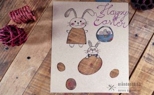 dibujo de conejos de Pascua con huevos y la inscripción Happy Easter