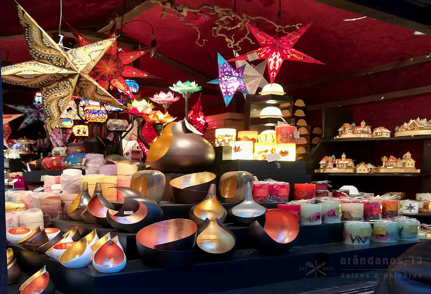 Puesto de mercadillo navideño con velas y luces